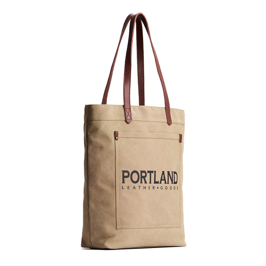 Beige tote bag with leather handles and 'Portland Leather Goods' text