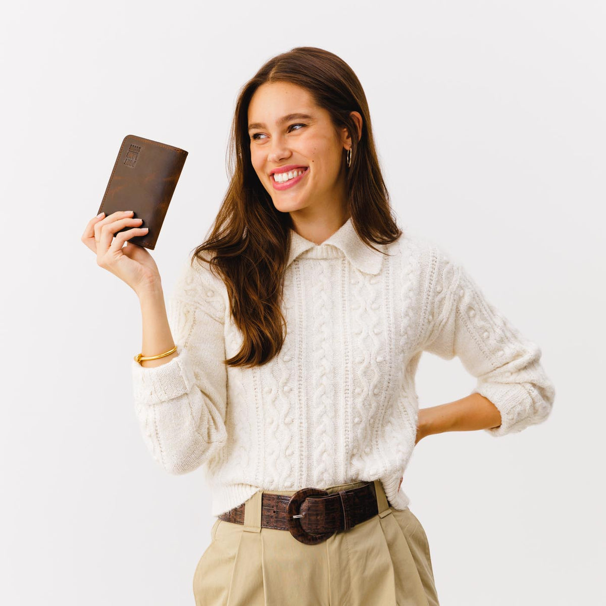 Canyon | Model holding leather passport case with PLG logo