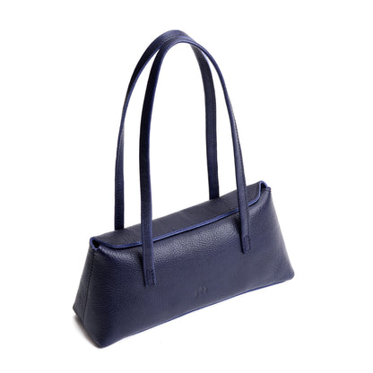Cobalt | Leather bowler bag with magnetic closure against a white background