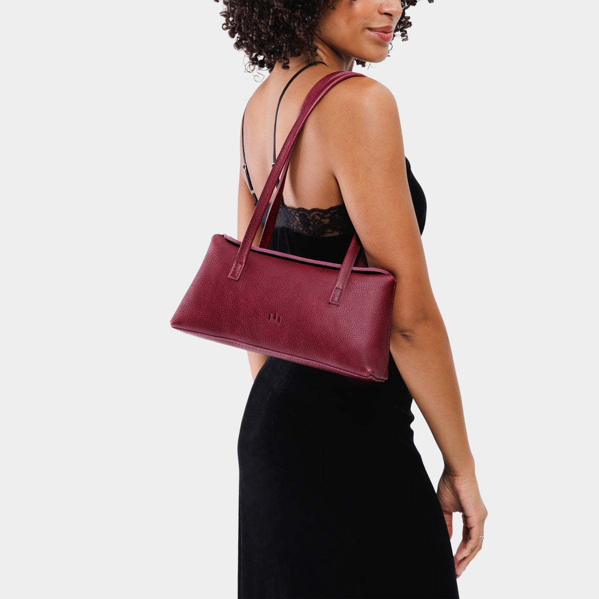 Orchid | Person holding leather bowler bag with magnetic closure