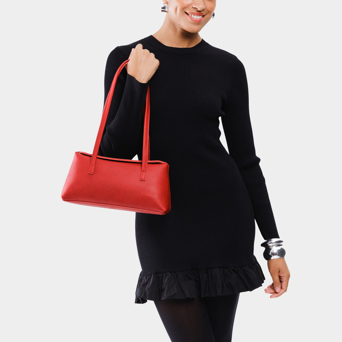 Ruby | Person holding leather bowler bag with magnetic closure