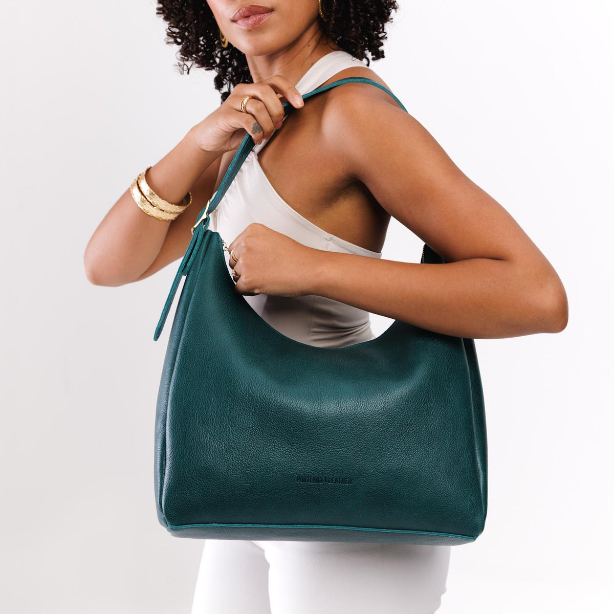Sea Glass*Large | Model holding u-shaped, flat-bottomed leather shoulder bag with adjustable strap