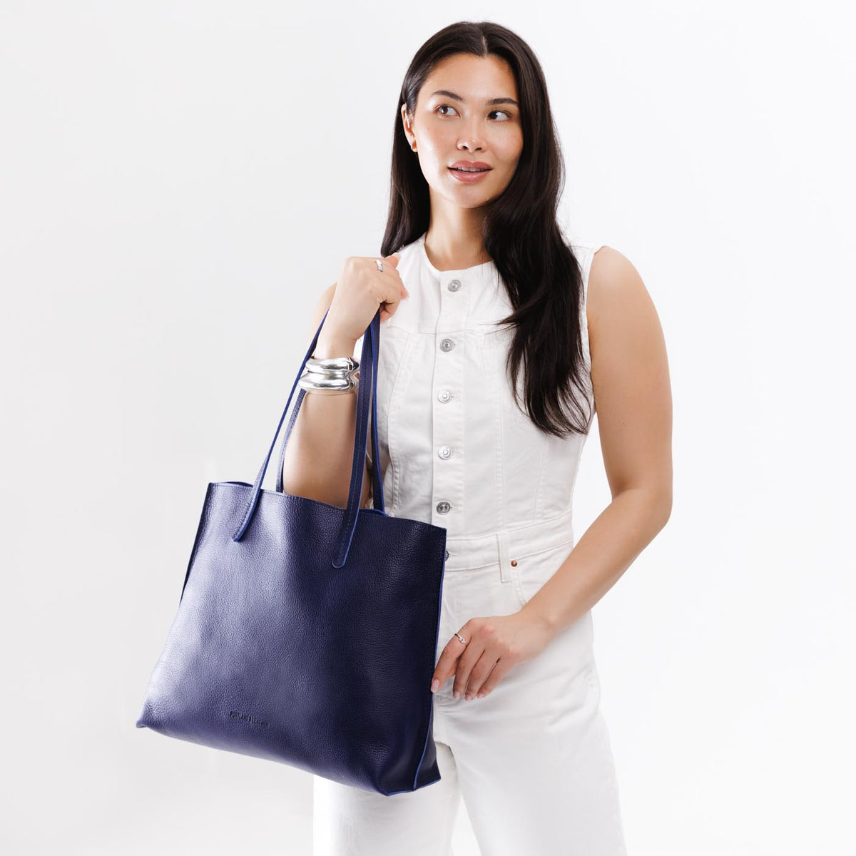 Cobalt*Large | Model holding leather tote bag with interior snap key loop