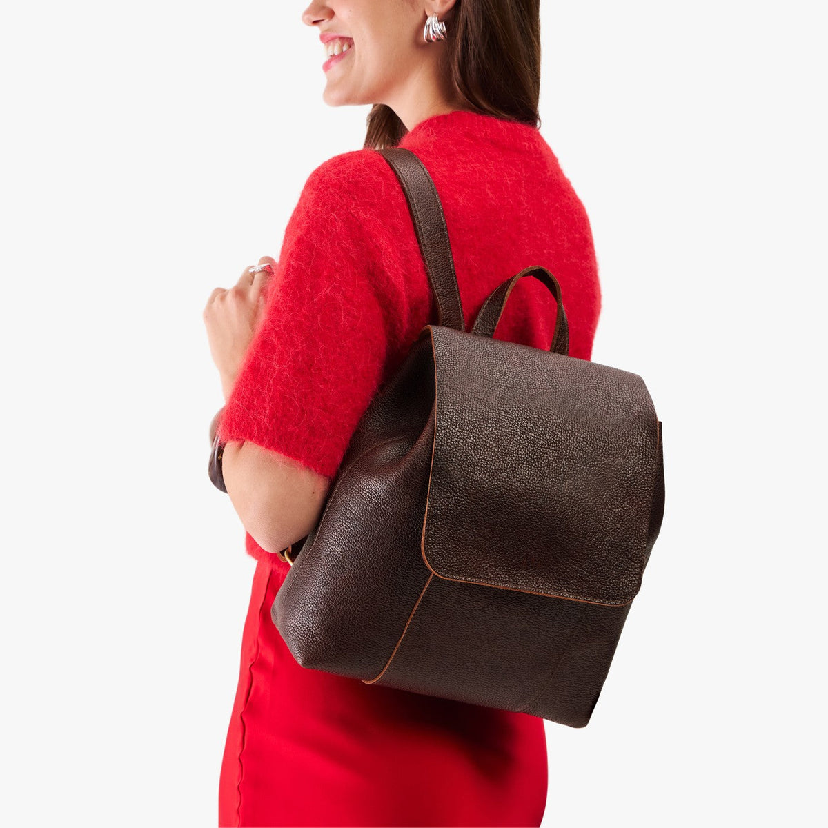 Coldbrew | Model wearing a leather backpack on a white background