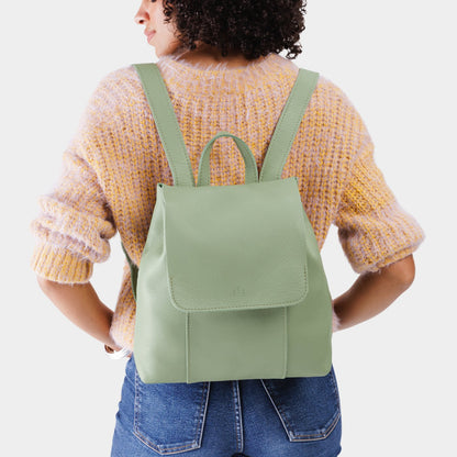Pistachio | Model wearing a leather backpack on a white background