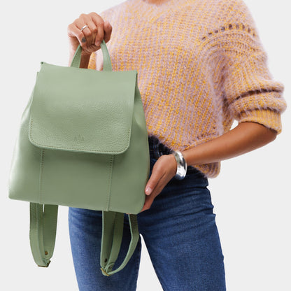 Pistachio | Model wearing a leather backpack on a white background
