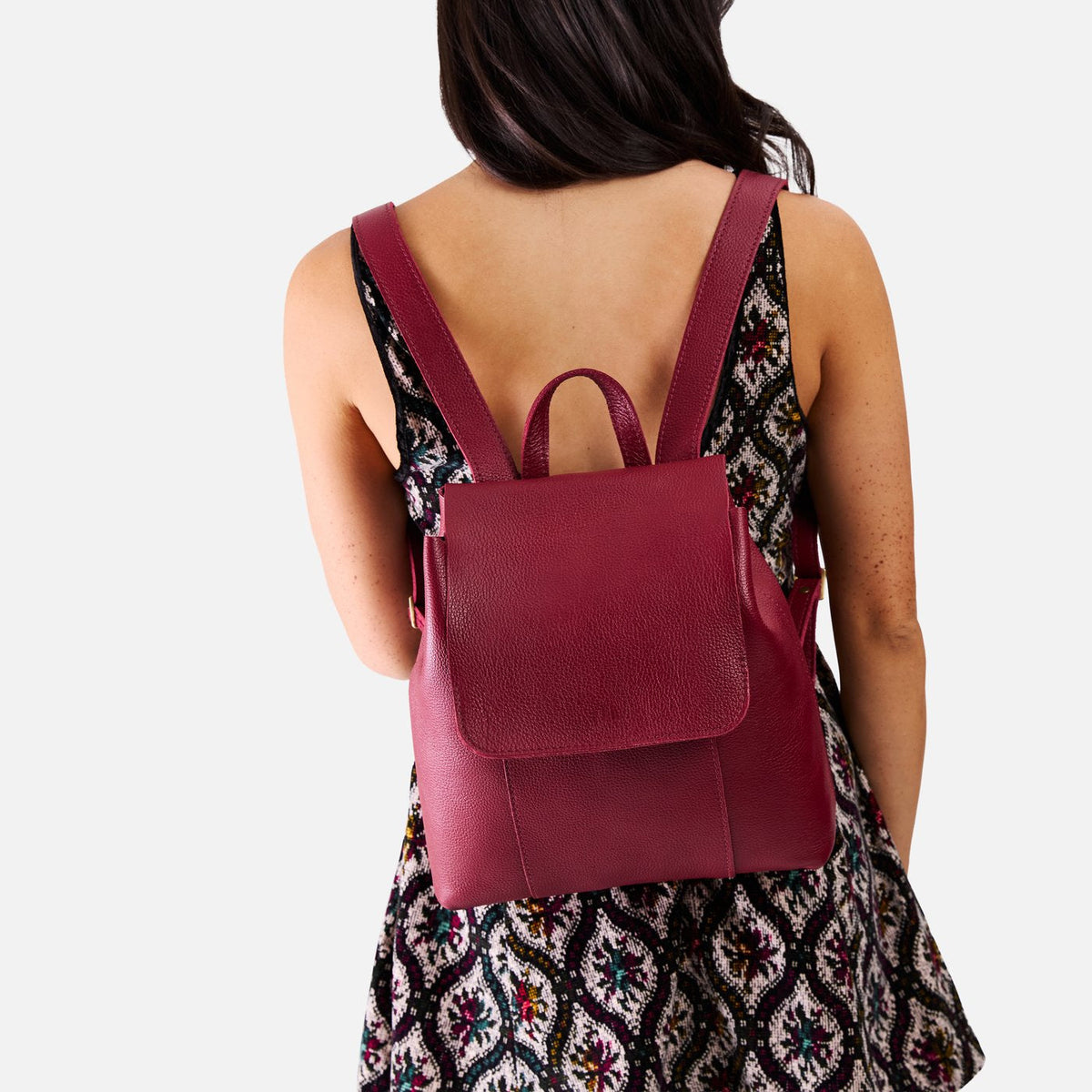 Rhubarb | Model wearing a leather backpack on a white background