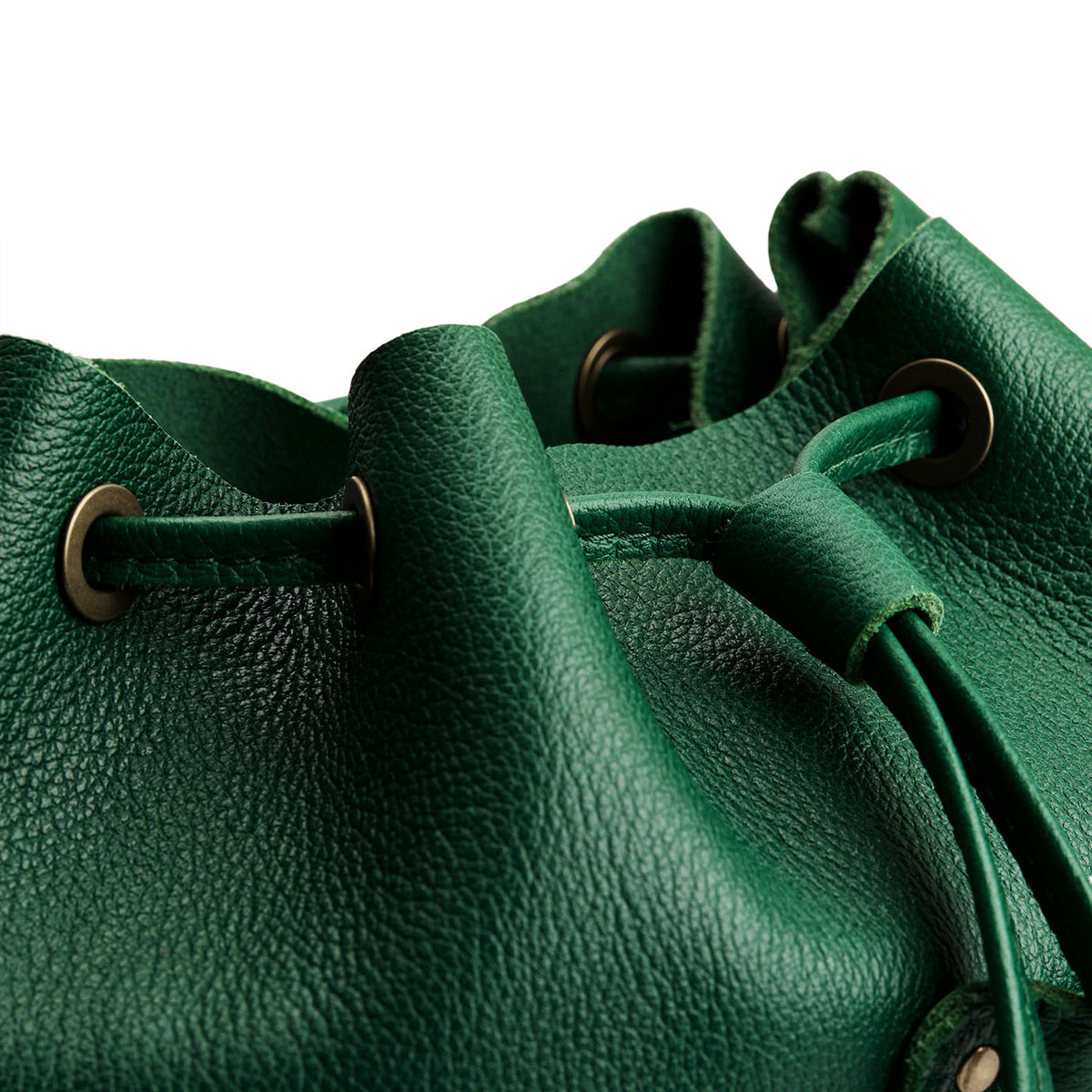 Bacalar | Close-up of leather drawstring backpack with grommets.