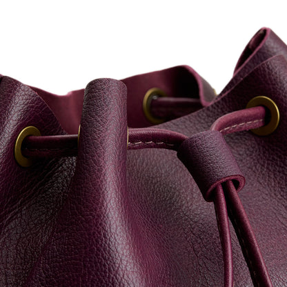 Plum | Close-up of slouchy crossbody bag with leather drawstring closure