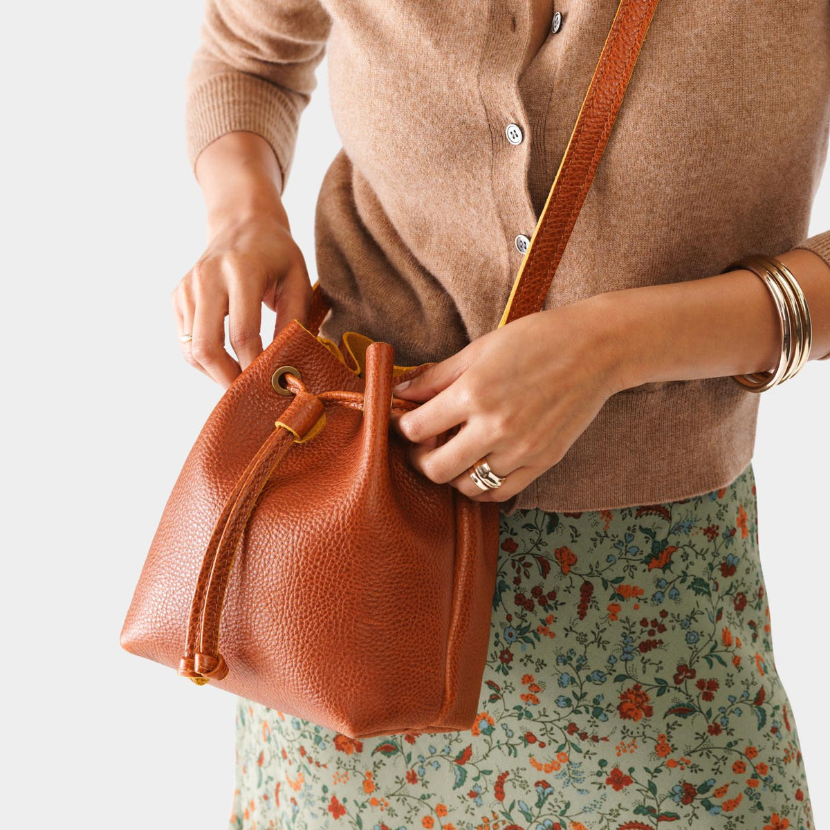 Sienna*Small | Model holding slouchy crossbody bag with drawstring closure