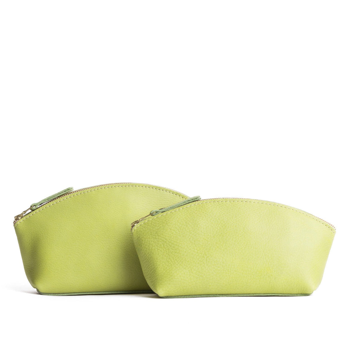 Sugar Snap | Size comparison shot of two spacious leather makeup bags with curved seams and top zipper