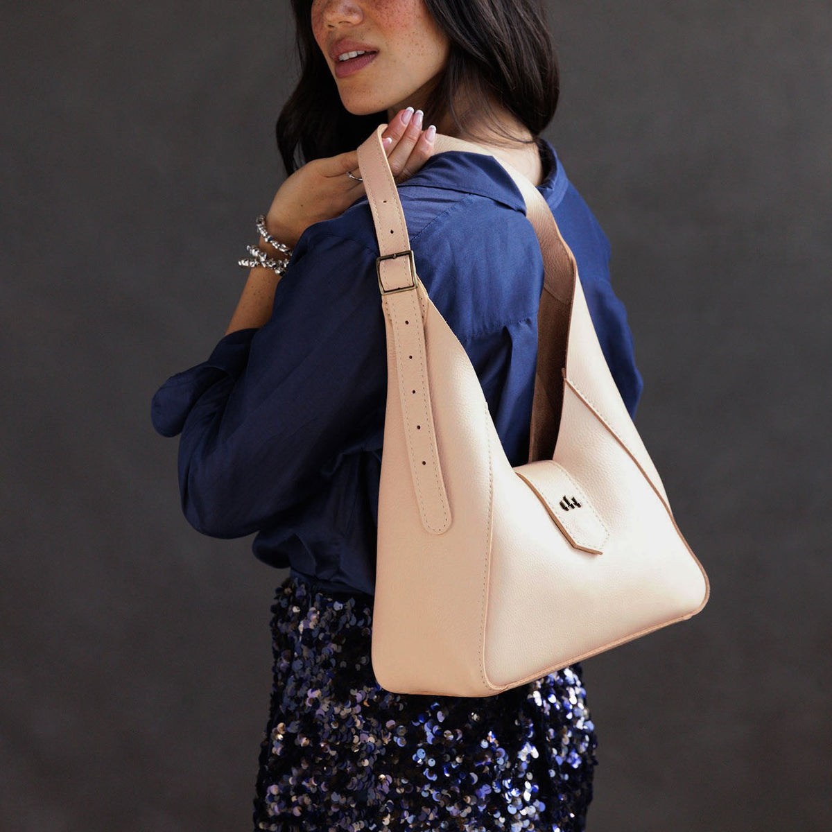 Moonflower | Model wearing structured hobo shoulder bag with adjustable strap and magnetic closure