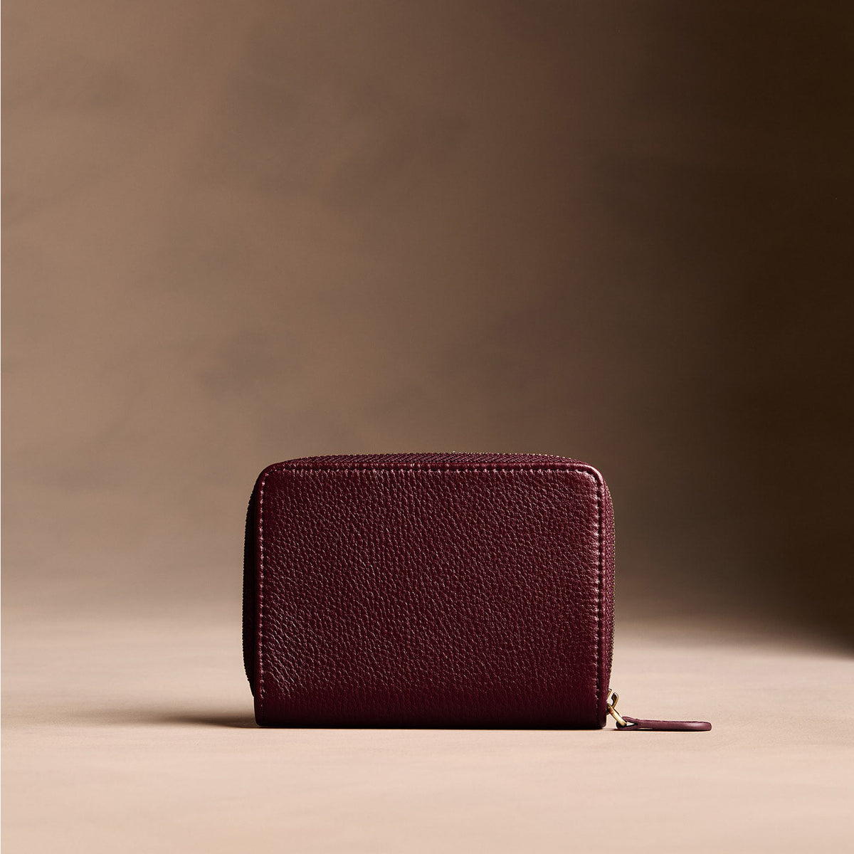 Hunter | Wallet with card and storage pockets on a light brown background - back view