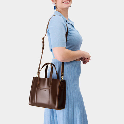 Chocolate Brown | Model wearing structured mid-size tote bag with overlapping panels and crossbody strap