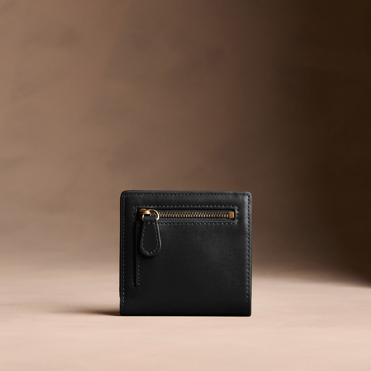 Onyx*Small | Petite slim leather bifold wallet with multiple card slots and a zippered back pocket - back view