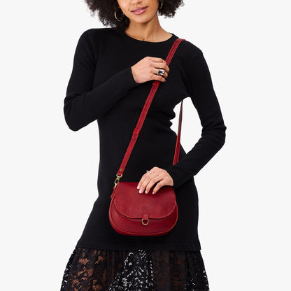 Chili Red*Small | Model wearing a petite leather Crossbody with a flap and magnetic closure
