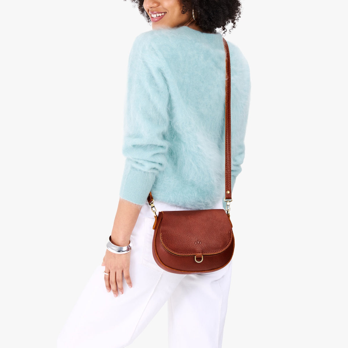 Nutmeg*Small | Model wearing a petite leather Crossbody with a flap and magnetic closure
