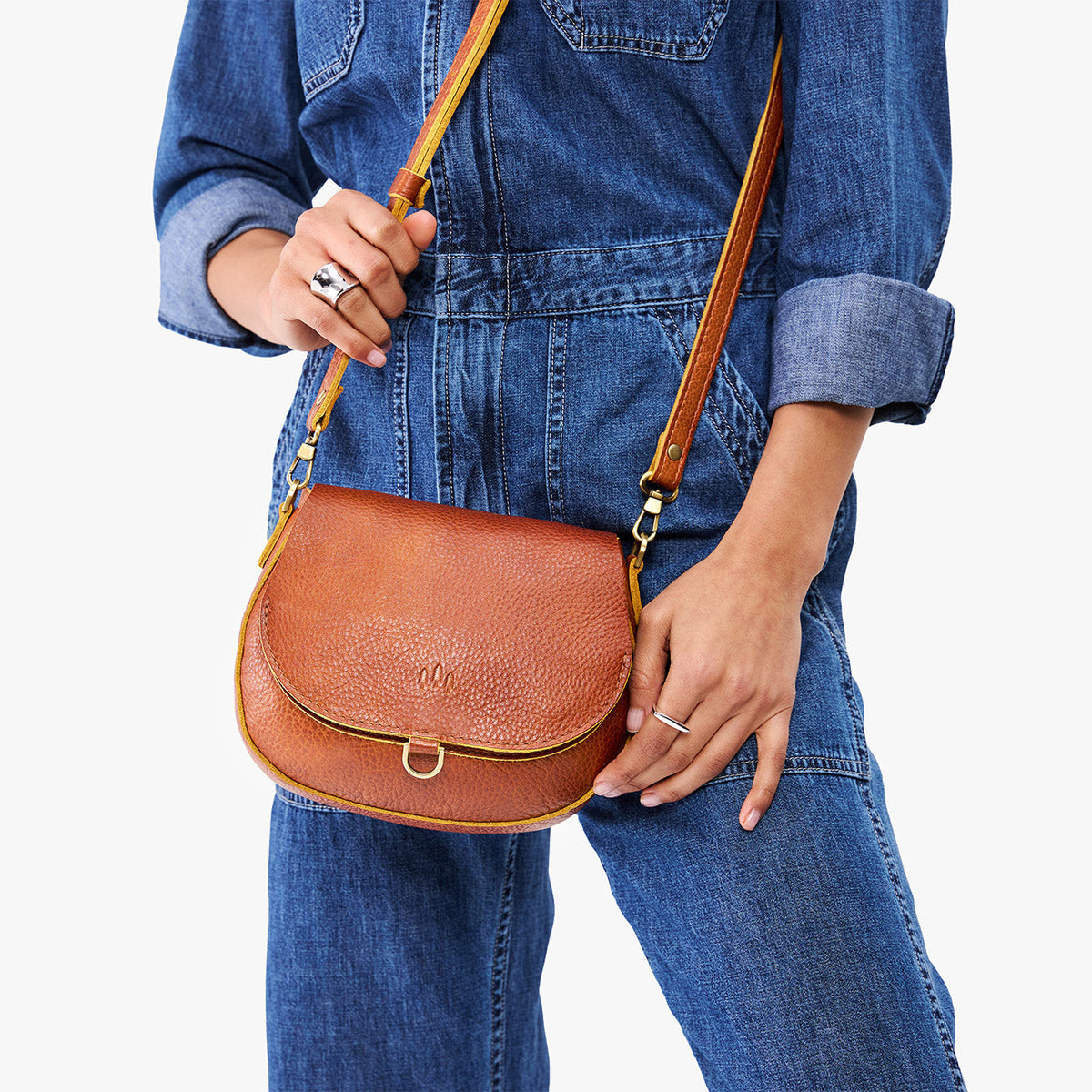Sienna*Small | Model wearing a petite leather Crossbody with a flap and magnetic closure
