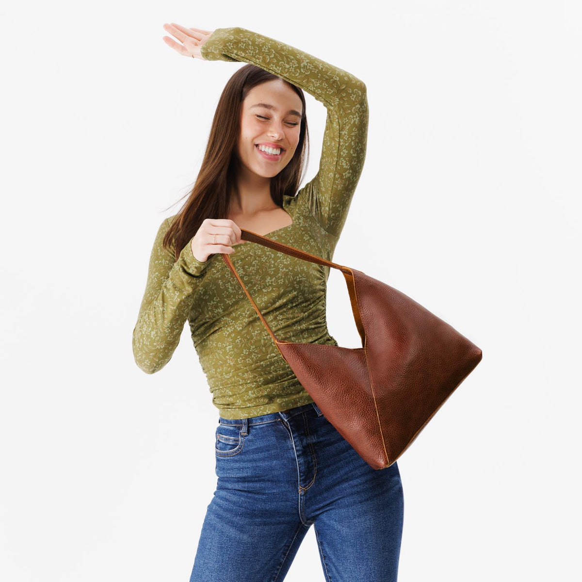 Nutmeg*Large | Model holding mid-size shoulder bag with magnetic snap closure