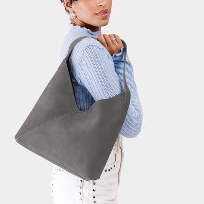 Smoke Grey*Large | Model wearing mid-size shoulder bag with magnetic snap closure