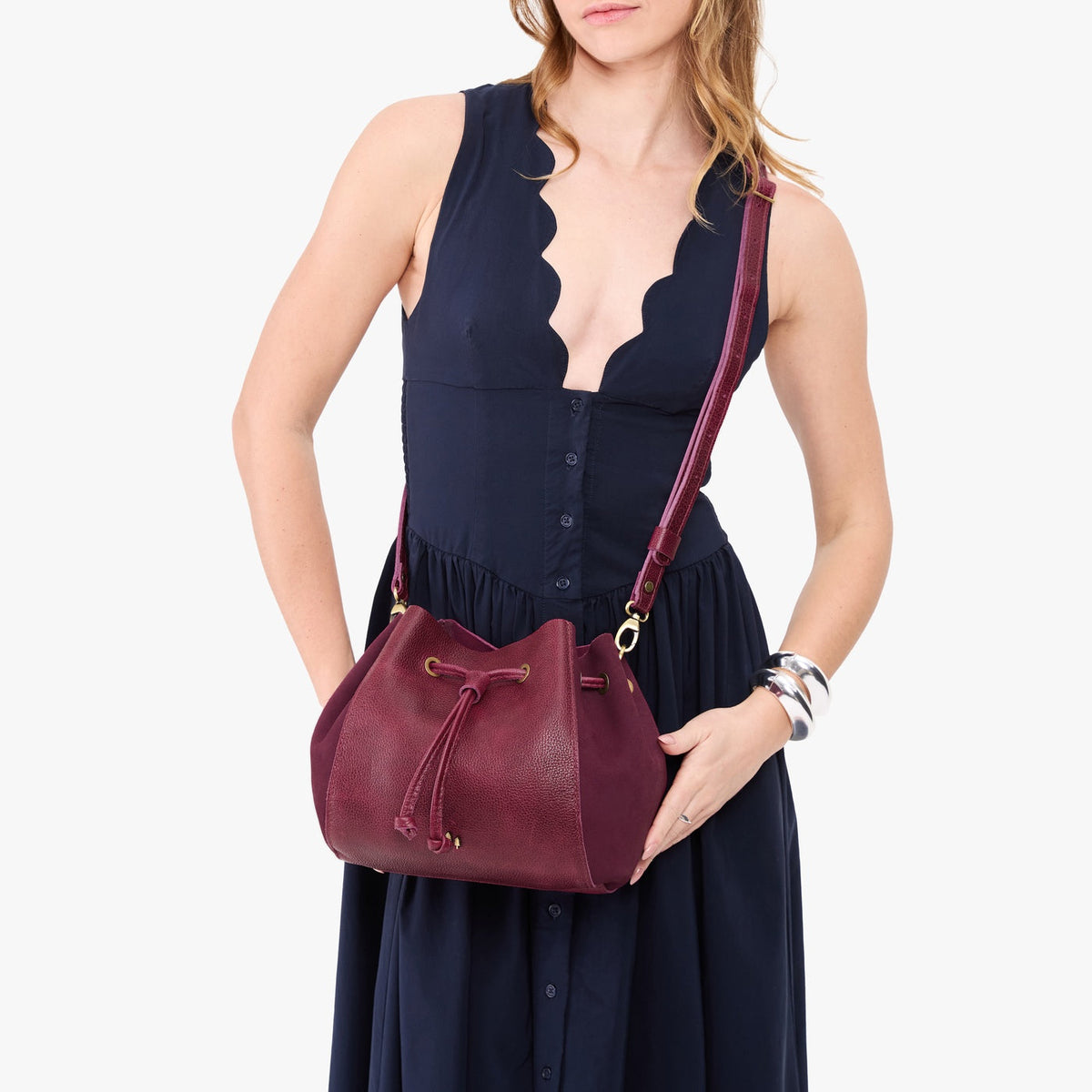 Orchid | Model wearing bucket bag with cinched drawstring closure