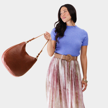 Nutmeg*Large | Woman wearing rounded shoulder bag with adjustable strap on a white background