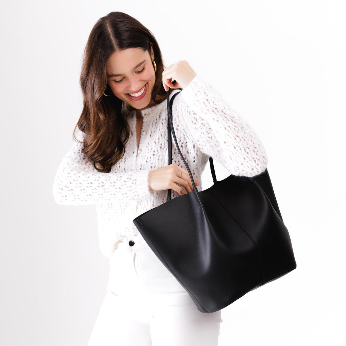 Black*Oversized | Model holding extra wide bucket shaped tote bag with matching leather handles