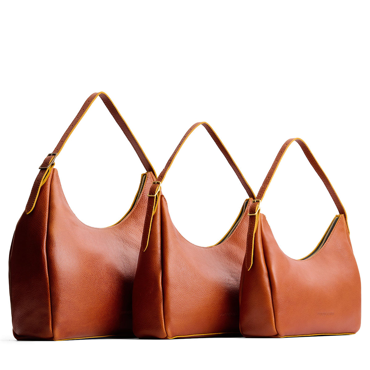 Sienna | Size comparison image of oversized, large, and medium u-shaped, flat-bottomed leather shoulder bags with adjustable strap