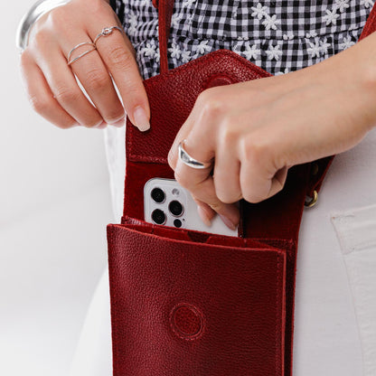 Chili Red | Model wearing slim, phone-shaped crossbody purse with magnetic closure