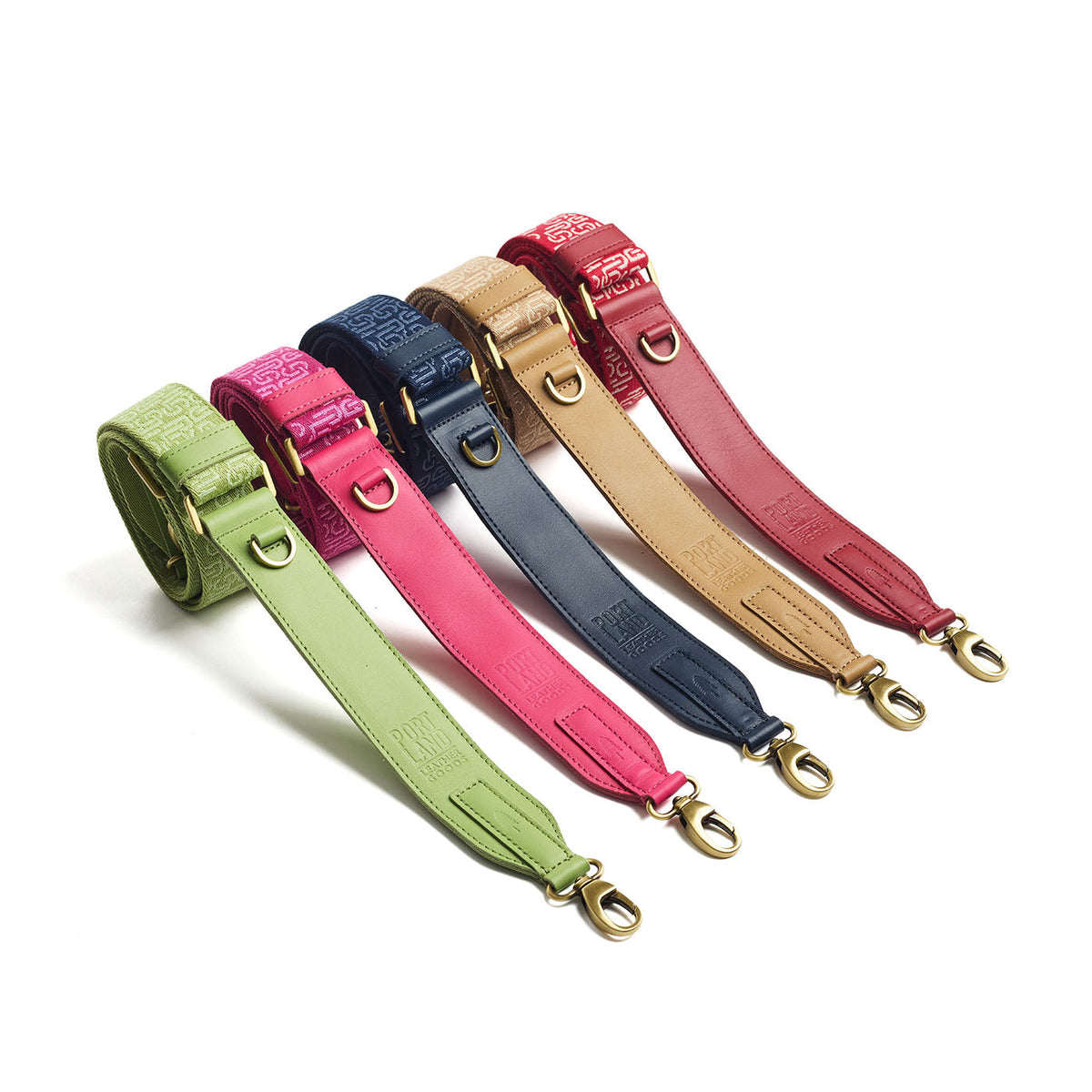 All Variants | Collection of leather and webbing straps with repeating PLG lettering on a white background