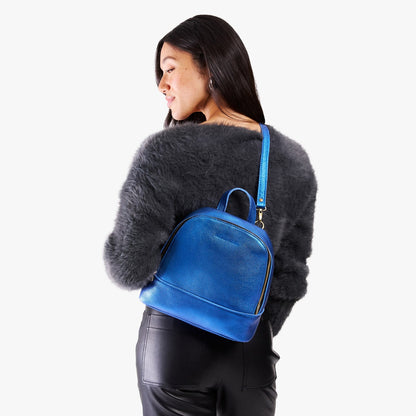 Comet Blue | Model wearing leather backpack sling bag style