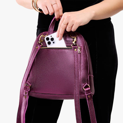 Ultra Violet | Model pulling smartphone out of back zipper pocket of a leather backpack