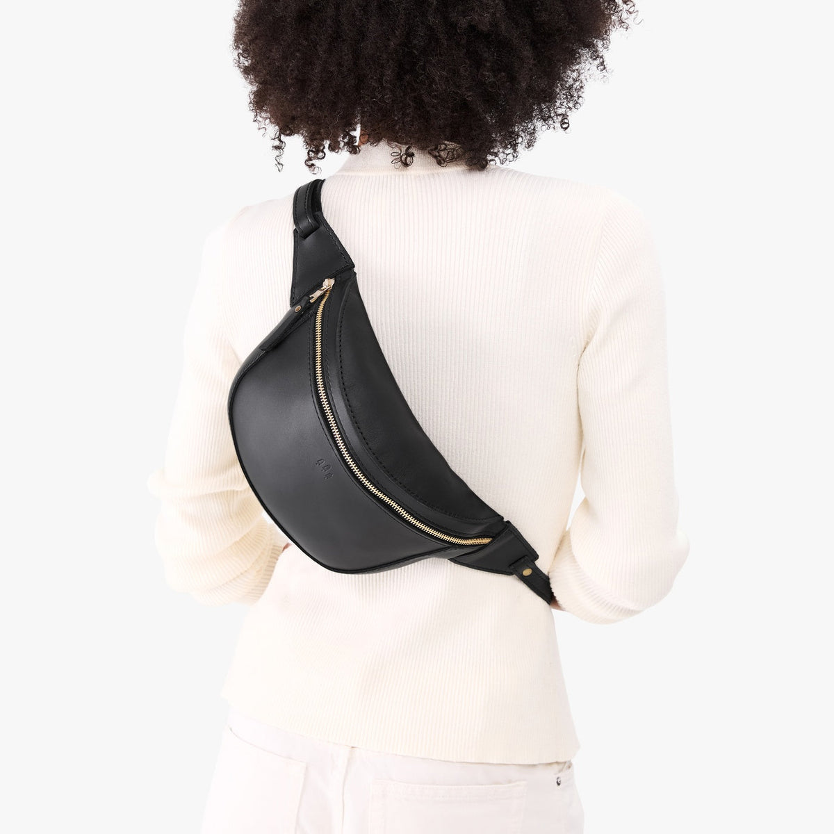 Black | Model wearing a sling bag with front zipper