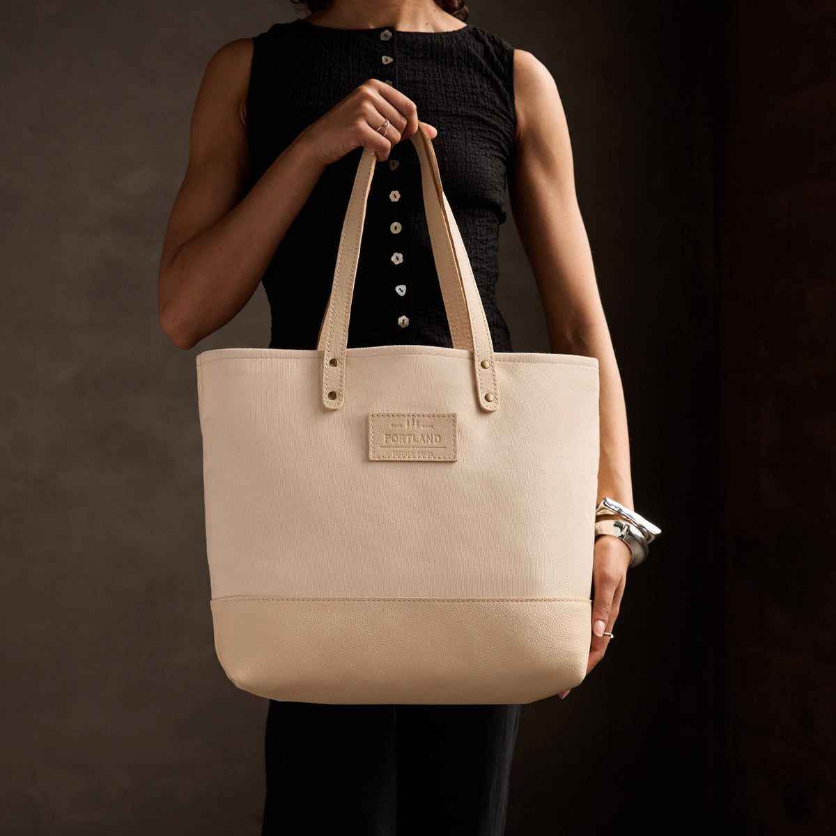Warm Sand | Model holding canvas tote with leather base and handles